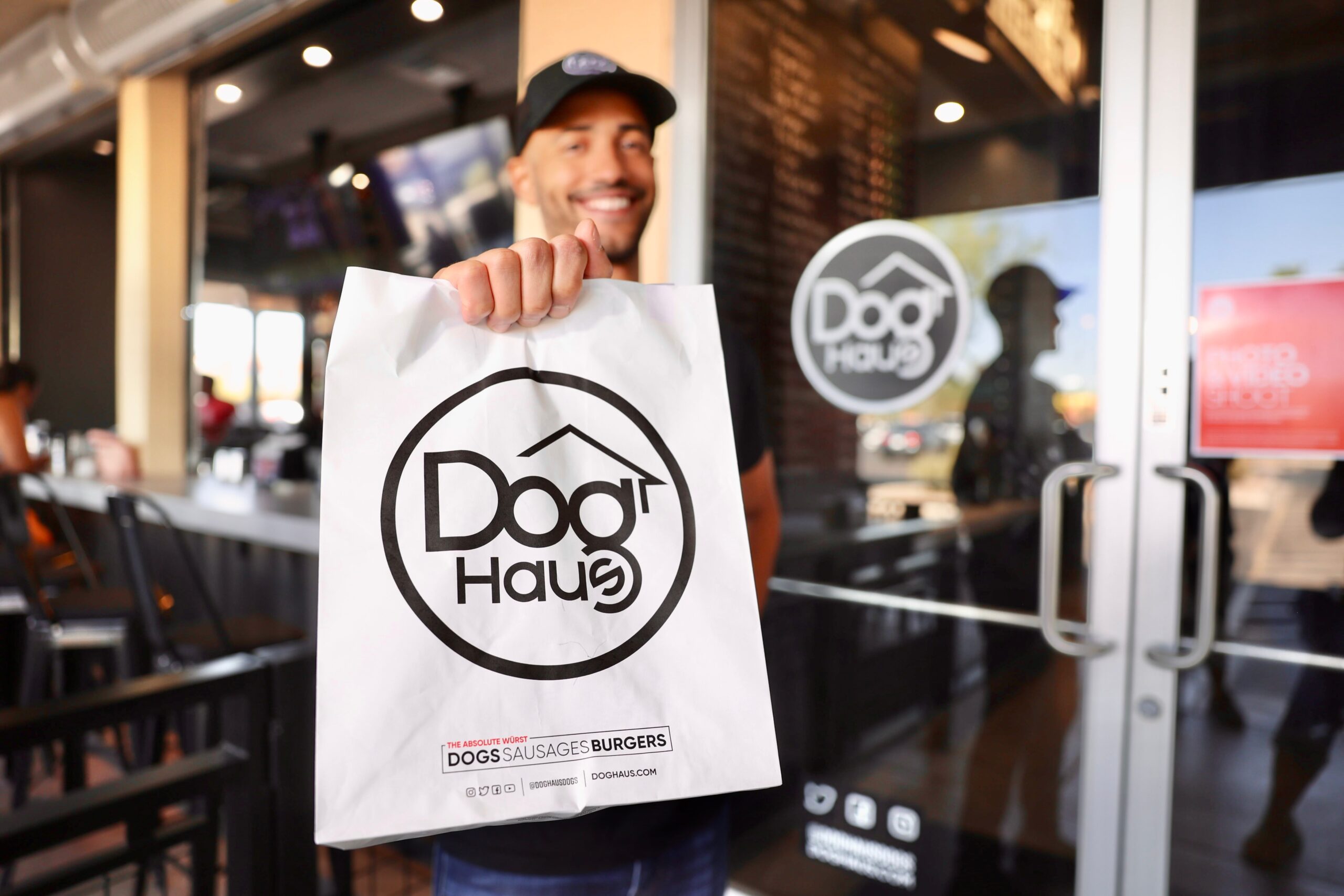Guest picking up a takeout order at Doghaus Chandler.